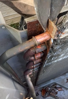Close-up of AC condenser copper pipe joints during refrigerant line repair in Bahrain