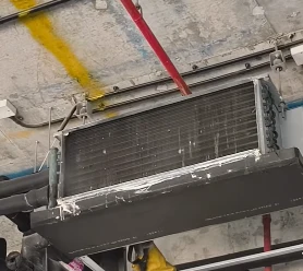 Dirty AC coil clogged with dust before cleaning, Bahrain