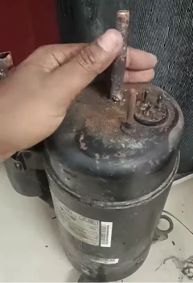 Failed old AC compressor removed during replacement, Bahrain