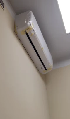 AC technician completing outdoor unit installation, Bahrain