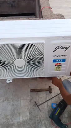 Technician installing new AC outdoor unit in Bahrain